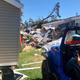 A BAJA member winching Dereck’s neighbor’s truck out from under the rubble.